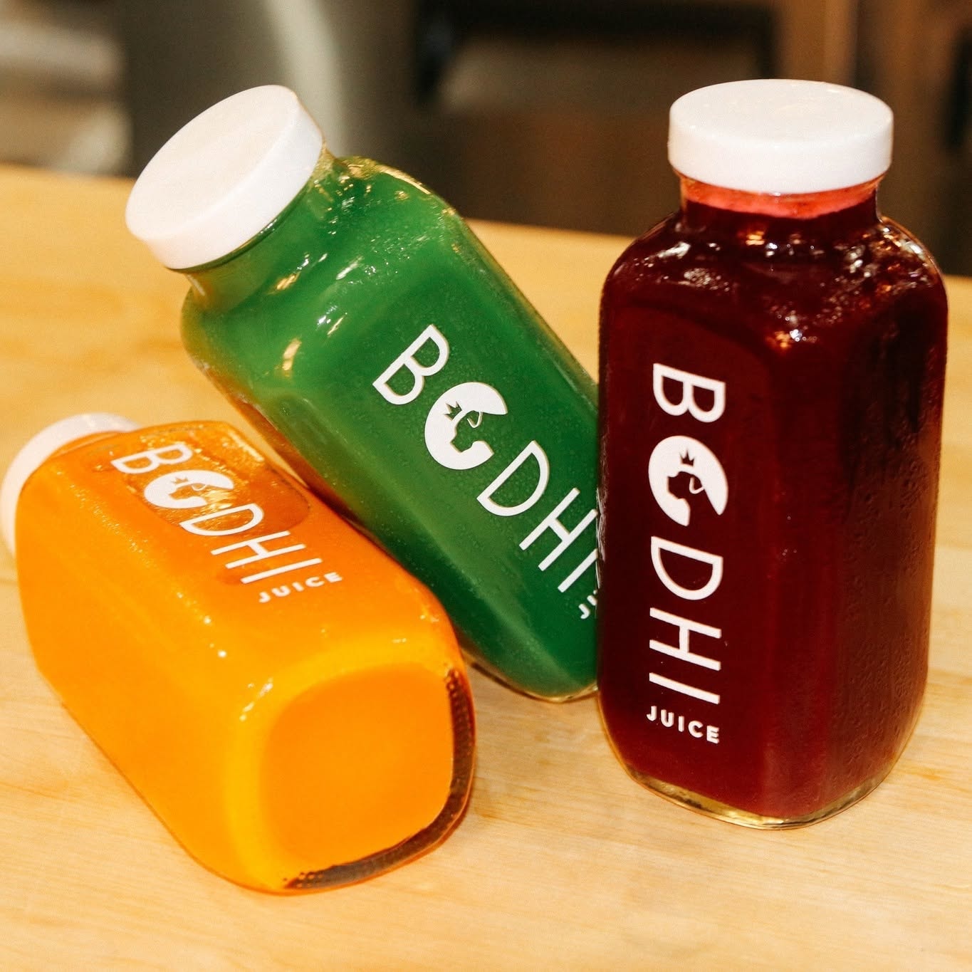 Three Bodhi fresh juice bottles in different flavors