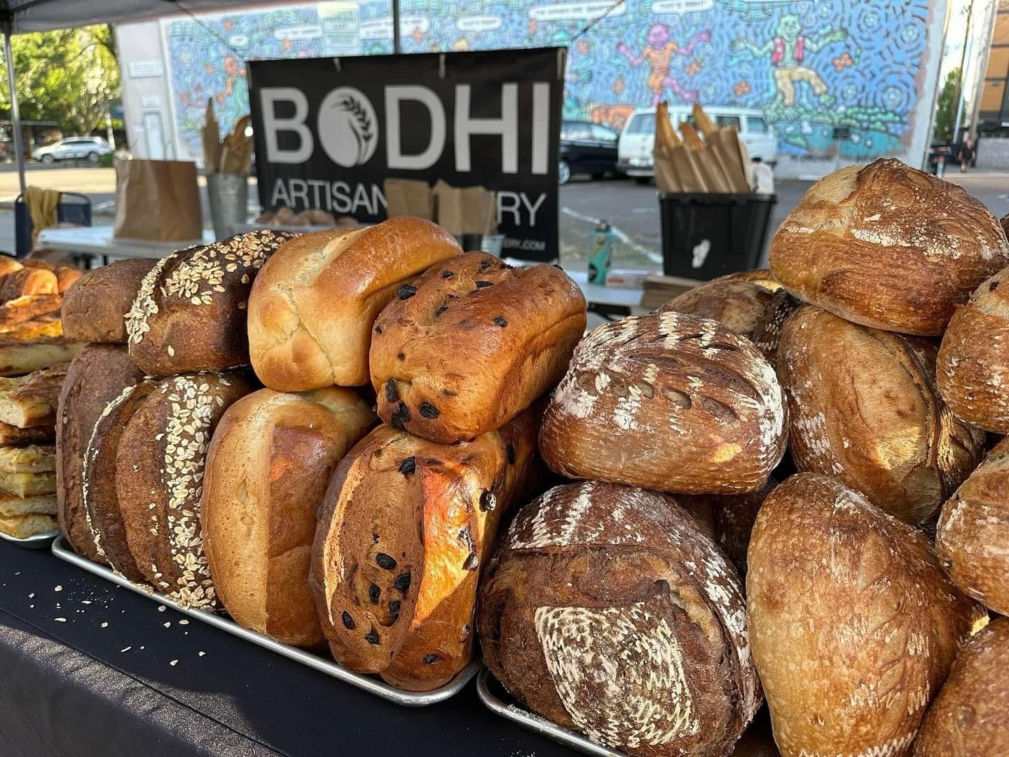 Fresh sourdough loaves and artisan bread at the Bodhi farmers market booth