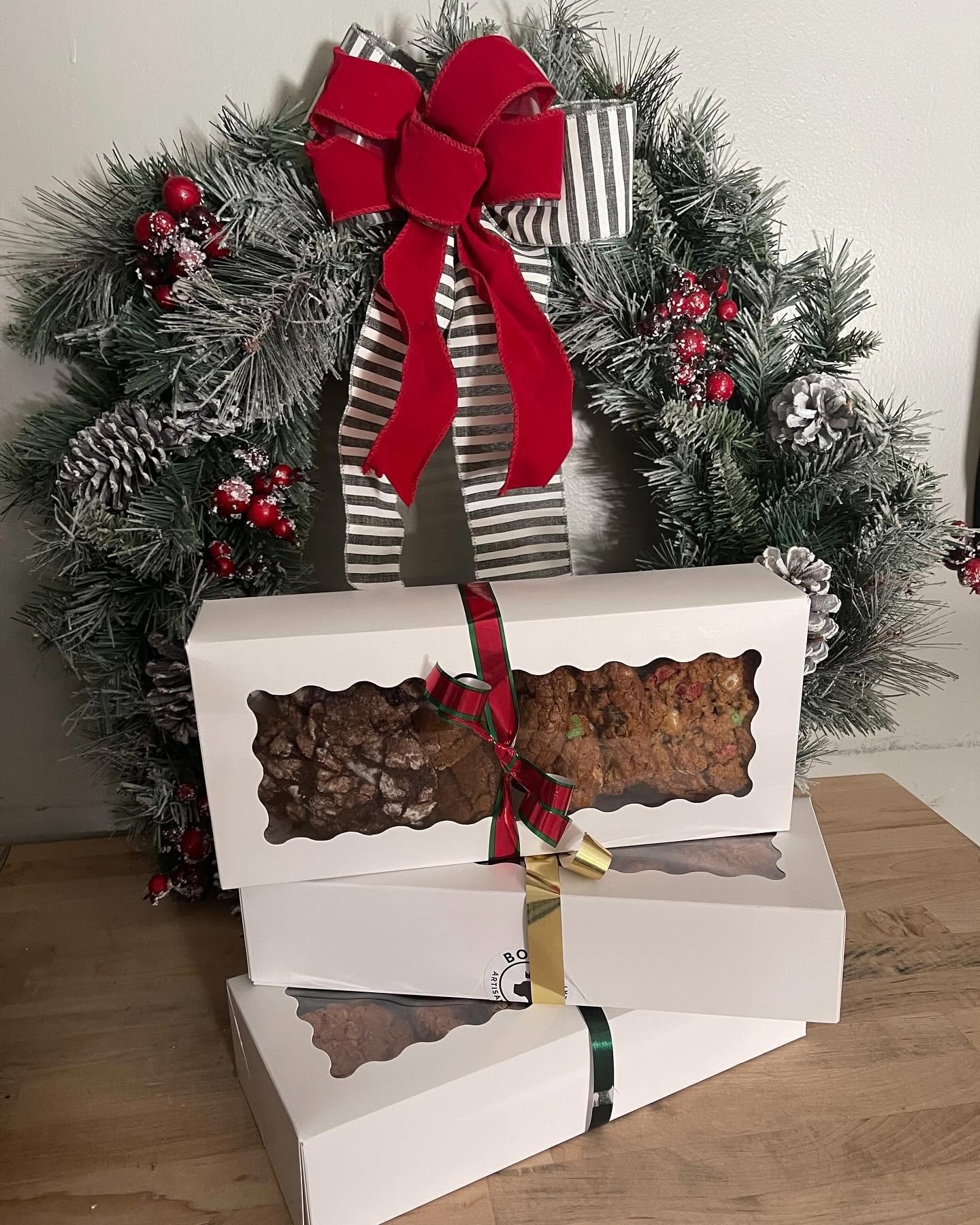 Bodhi holiday cookie boxes stacked with festive wreath and ribbon